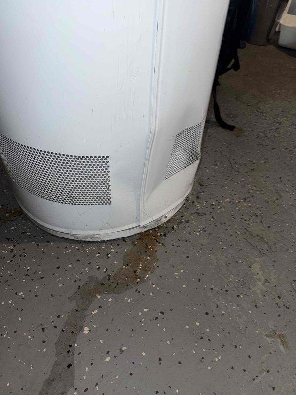 Responded to no hot water complaint for 10+ year old tanked water heater located in basement. Diagnostic inspection revealed water leaking from tank base with visible corrosion around bottom ventilation panels. Replaced failed water heater with new unit, including proper connection of hot/cold water lines and exhaust venting, restoring hot water service to residence.