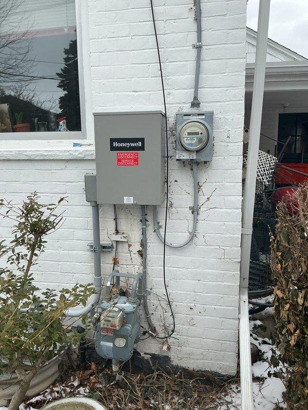 Performed comprehensive electrical system inspection as part of whole-home electrical special, including examination of exterior utility connections (Honeywell control box and digital meter) and interior circuit breaker panel. Conducted thorough assessment of the main panel, identifying multiple circuit breakers and verifying proper wire connections throughout the system.