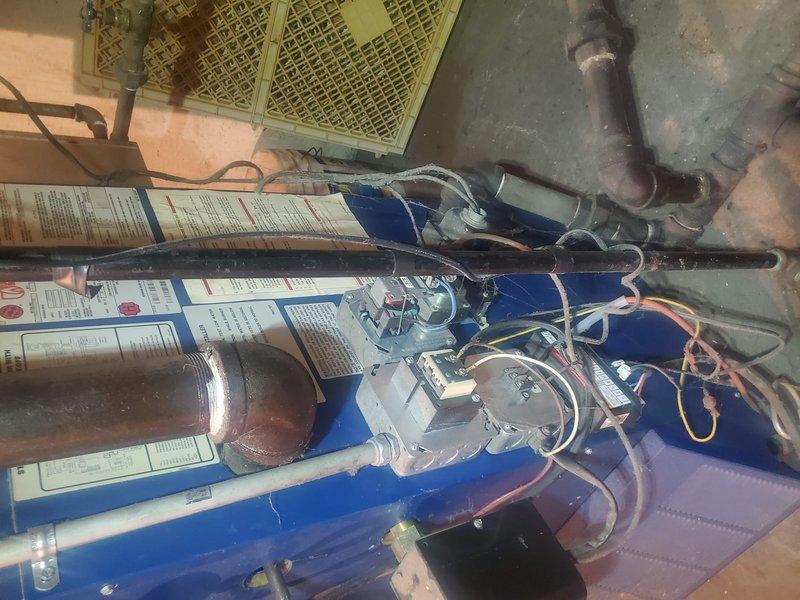 Performed comprehensive boiler inspection and maintenance on aging steam boiler system (10+ years old). Inspected burner assembly, confirming proper flame pattern and heat exchanger function. Examined all connections, controls, and safety systems; system is operational but customer's maintenance plan requires renewal for continued coverage.