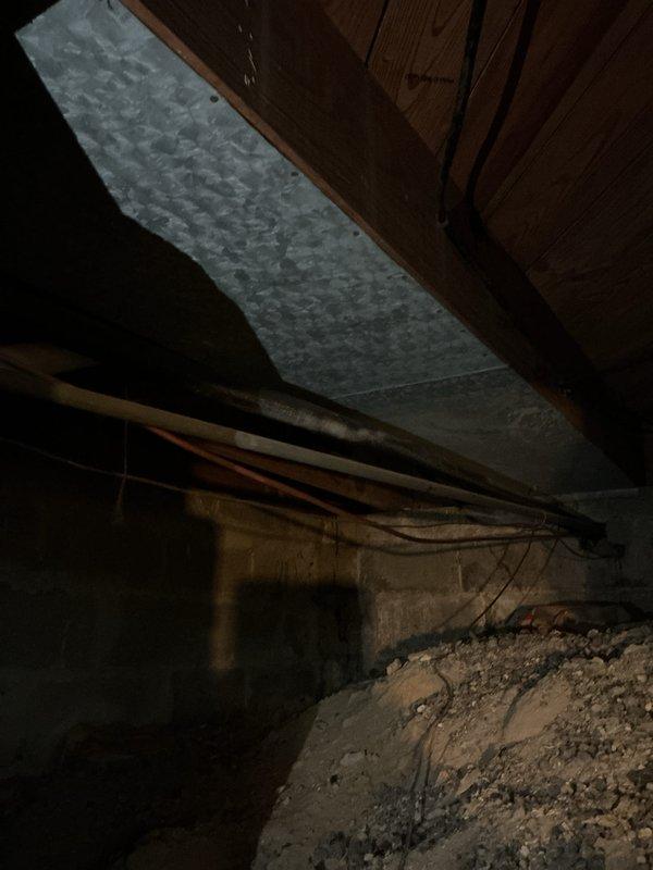 Conducted diagnostic evaluation on 10+ year old basement furnace with non-igniting pilot light. Visual inspection revealed failed heat exchanger, which was documented with photos of the main unit and surrounding crawlspace area. Presented replacement options to customer due to the critical safety concern of the failed component.