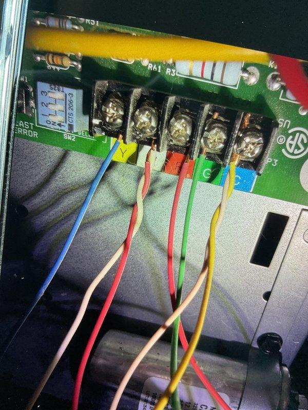 Responded to service call for 2019 furnace that was not achieving setpoint temperature despite thermostat replacement. Diagnostic testing revealed improper voltage readings at the control board terminal connections, with measurements taken using a Klein Tools CL390 clamp meter. After inspecting and reconnecting the color-coded wiring (blue, white, red, green, yellow) at the terminal block, system operation was restored to normal function with proper temperature control.