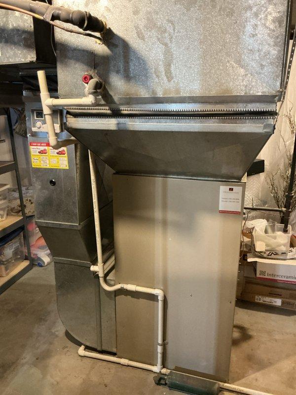 Performed inspection of 25-year-old HVAC system with faulty blower wheel causing noise issues. Identified damaged blower assembly in existing furnace unit located in basement utility area. Provided comprehensive replacement estimate for complete system due to equipment age and potential repair costs exceeding replacement value. Documented current installation configuration including existing ductwork connections and PVC venting system for proper sizing of replacement equipment.