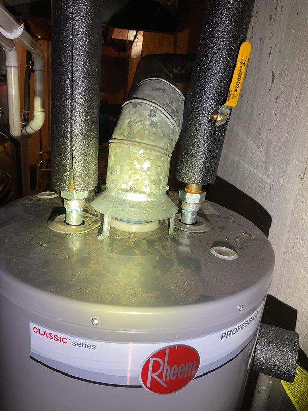 Performed Gold Furnace Inspection on 10-month old forced air system located in basement. Unit was operational upon arrival. Inspected Rheem Classic water heater, noting some discoloration on vent pipe that may indicate early signs of corrosion. Examined insulation and structural components in surrounding utility space, with all systems functioning within normal parameters.