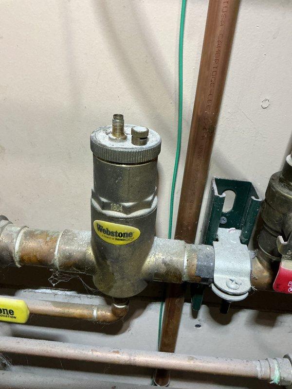 Performed scheduled maintenance service on an 8-year-old residential boiler located in pantry. Inspected valve assembly and copper piping connections, noting minor pipe discoloration but confirming proper operation. System functioning correctly with no heat loss issues identified; left unit in good working condition.