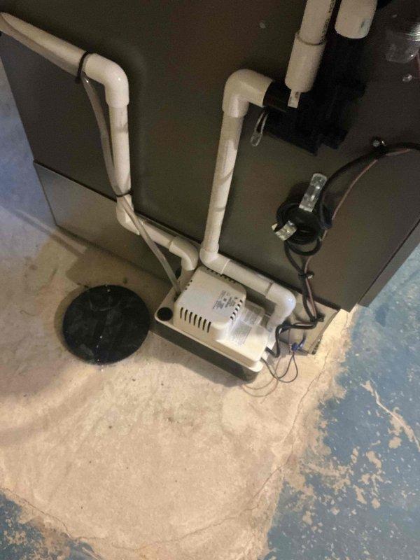 Relocated condensate pump from above floor cleanout to provide proper access. Verified drainage system functionality and confirmed all connections secure on Lennox HVAC system. Condensate line configuration now meets installation standards with proper clearance for cleanout access.