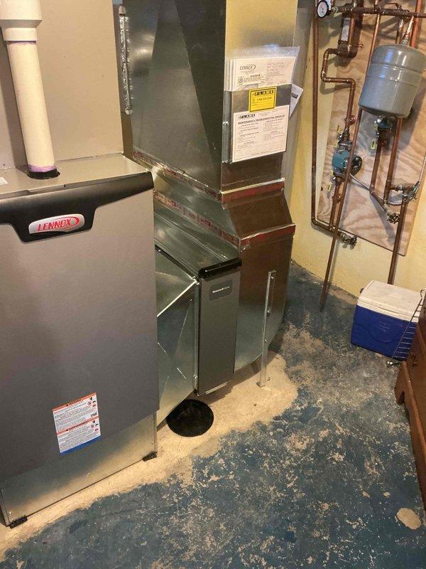 Relocated condensate pump from above floor cleanout to provide proper access. Verified drainage system functionality and confirmed all connections secure on Lennox HVAC system. Condensate line configuration now meets installation standards with proper clearance for cleanout access.