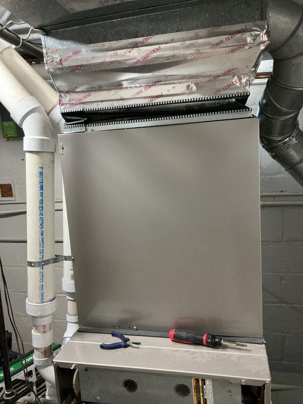 Conducted comprehensive inspection of 10+ year old furnace system located in basement. Documented existing installation including main unit with metallic cabinet, ventilation components, and PVC exhaust configuration. Prepared replacement quote for aging HVAC system with detailed specifications for upgraded equipment.