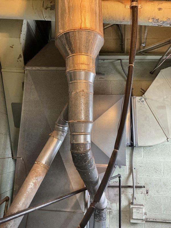 Completed installation of a new Bradford White 40-gallon commercial water heater, replacing the heavily corroded existing unit. Work included installing new dielectric unions, 3/4" ball valve shutoff on feed line, new gas valve and piping, and replacing the vent wye with a new 5x4x4 wye to reconnect existing furnace venting. Unit was elevated on bricks, filled, tested for proper operation, and verified leak-free.