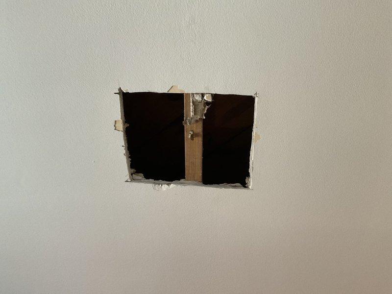 Performed follow-up inspection of previously identified ceiling water leak (Job #1230138). Cut access holes in drywall to investigate source of leak, revealing continued water damage that has spread since October assessment. Visual inspection confirmed ongoing moisture issues in the ceiling cavity. Documented current condition with photographs for comparison to previous assessment.