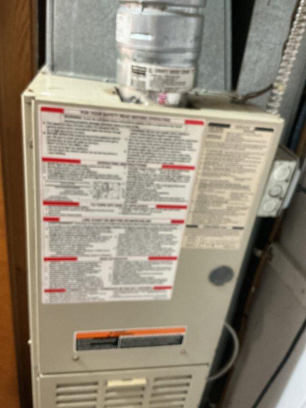 Performed diagnostic assessment on 10+ year old downflow furnace with cracked heat exchanger in mechanical room behind church. Inspection revealed non-functional secondary furnace failing to light or produce heat. Recommended full replacement as repair costs would be prohibitive given the extensive damage and age of the system.