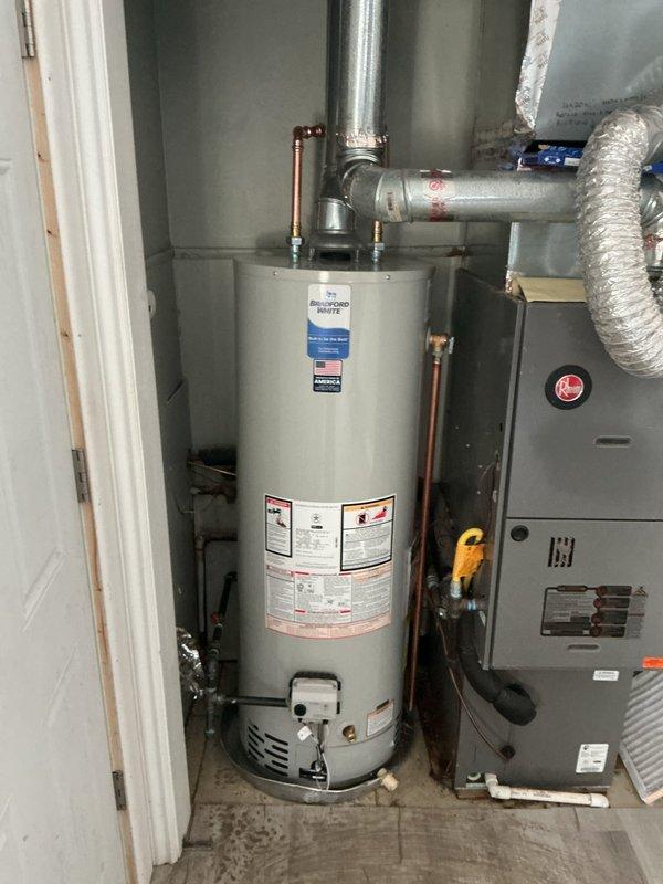 Installed new 40-gallon standard hot water heater with code-compliant upgrade of flue pipe from 3" to 4". Repaired multiple burst pipes in crawl space and installed hard pipe gas line connection. Added safety drip pan with alarm system to prevent water damage.