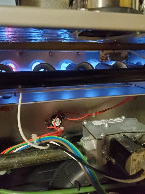 Performed diagnostic assessment on 6-year-old heating system that was running but failing to maintain temperature. Inspected gas burner assembly which showed proper blue flame pattern and normal operation. Verified thermostat functionality and confirmed Nest smart thermostat was correctly communicating with the system. Determined issue was related to improper system cycling causing temperature drops; adjusted control parameters and verified continuous operation through complete heating cycle.