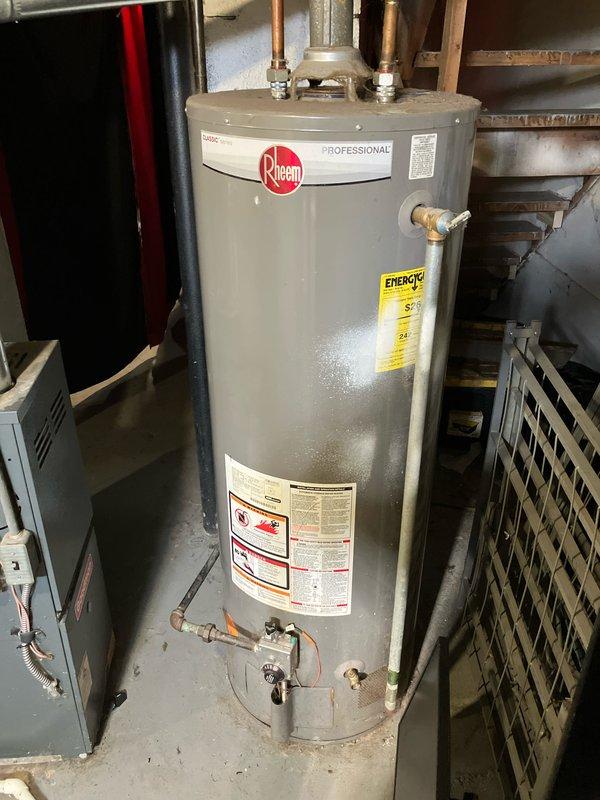 Performed diagnostic assessment on 2005 HVAC system in duplex basement (W unit) that was not producing heat. Found multiple issues including dirty flame sensor, inoperable toggle switch, and water-damaged control board. Temporarily restored operation by resetting system at breaker. Provided replacement options for this 18+ year old unit with documented water damage and control issues.