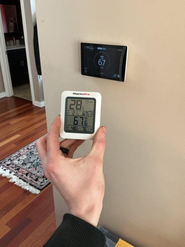Responded to service call for S40 thermostat reporting inaccurate temperature readings. Verified discrepancy using calibrated thermometer probes, with readings showing 71°F at thermostat location versus 68°F elsewhere in room. Adjusted thermostat calibration to maximum setting to achieve more accurate temperature measurement. Recommended customer monitor comfort levels over 1-2 week trial period, with potential replacement scheduled for spring if issues persist.