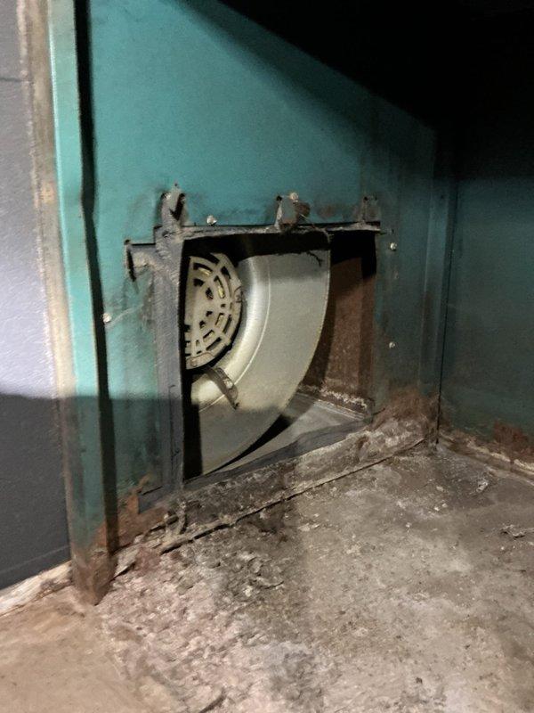 Responded to service call for 7-year-old furnace in basement that was cycling on and off intermittently. Diagnostic inspection revealed significant corrosion and deterioration on the heat exchanger cabinet, particularly around the blower assembly access panel. Observed damaged foil tape on ductwork connections and signs of extended wear on critical components. Recommended heat exchanger replacement to prevent complete system failure and restore proper operation.