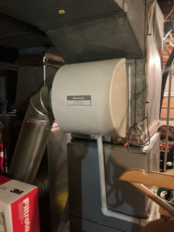 Completed Gold Furnace Inspection on 10+ year old residential basement furnace. Verified proper burner operation with clean blue flame pattern and inspected gas valve assembly functionality. Examined Honeywell humidifier installation and confirmed proper connection to ductwork; noted presence of Filtrete filtration system.
