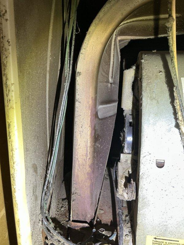 Responded to no-heat call for 2006 furnace in mobile home kitchen closet. Diagnosed flame roll-out issue occurring when inducer motor activates, caused by severe heat exchanger deterioration and corrosion as evidenced by internal inspection. Recommended complete system replacement due to age (17 years), safety concerns, and extensive heat exchanger damage beyond economical repair.