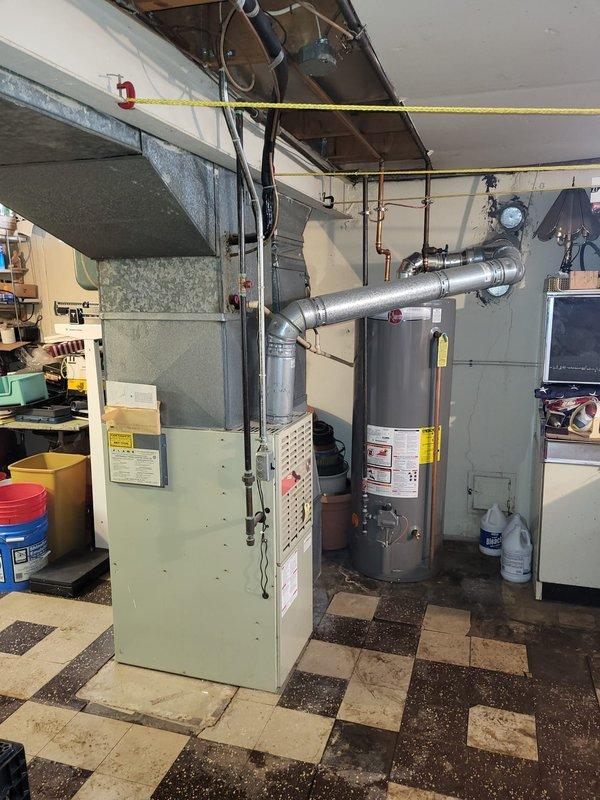 Performed diagnostic assessment on non-operational 33-year-old furnace with confirmed cracked heat exchanger in basement location. Documented corrosion and oxidation on copper piping with visible green patina formation. Presented replacement options to customer including: 1) furnace only, 2) furnace and AC combination, or 3) complete system upgrade with furnace, AC, and generator.