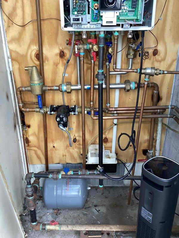 Inspected 3-year-old combi boiler system that failed due to freezing, causing unit explosion and operational failure. Performed diagnostic evaluation of the wall-mounted system including control electronics, expansion tank, and associated plumbing components. Documented damage to recommend appropriate replacement solution, noting additional plumbing repairs needed in crawlspace that should be addressed during system replacement.