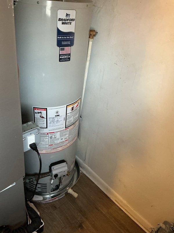 Successfully installed new Bradford White tanked water heater with proper connections to existing copper water lines. Installed drip pan with alarm as required by code, and completed all necessary venting with metallic vent piping. All connections were verified for proper function with no leaks observed.