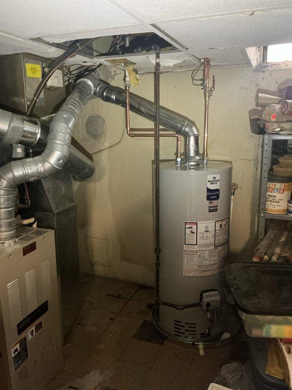 Successfully installed a new 40-gallon short natural gas water heater with proper safety components including drain pan, water alarm, and new gas valve. Upgraded plumbing with cold water riser featuring ball valve, humidifier stop, and hammer arrestor. Completed chimney liner replacement with new cap installation and reconfigured 5" dryer vent for improved ventilation. Replaced furnace filter (20x25x4) as part of comprehensive service.