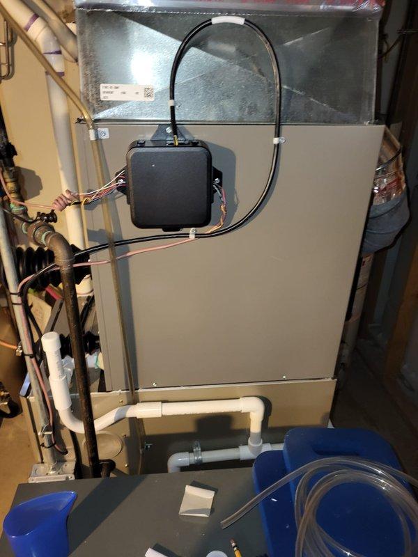 Performed diagnostic assessment on inoperative 8-year-old furnace system located in basement. Visual inspection revealed control box issues with multiple wiring concerns and possible condensate drain complications. Recommended complete system replacement due to age and non-functional status. Current setup includes metal ductwork with elbow joints, galvanized sheet metal sections, and PVC condensate lines that will need to be reconfigured for new installation.