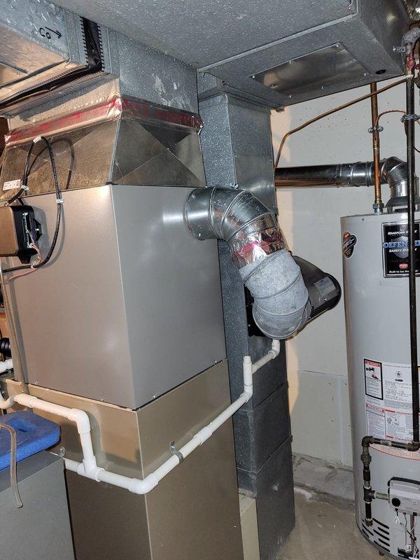 Performed diagnostic assessment on inoperative 8-year-old furnace system located in basement. Visual inspection revealed control box issues with multiple wiring concerns and possible condensate drain complications. Recommended complete system replacement due to age and non-functional status. Current setup includes metal ductwork with elbow joints, galvanized sheet metal sections, and PVC condensate lines that will need to be reconfigured for new installation.