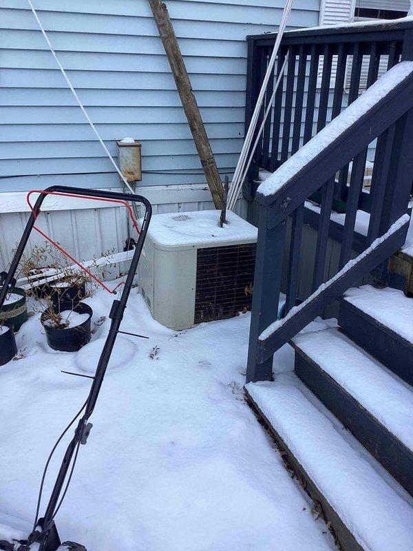 Performed diagnostic assessment on non-functioning 2006 furnace in mobile home kitchen closet installation. Identified flame rollout condition occurring when blower activates. Recommended complete replacement of 20-year-old system due to age and safety concerns, with optional AC replacement also discussed. Exterior inspection revealed existing outdoor condenser unit installed adjacent to home's exterior wall.