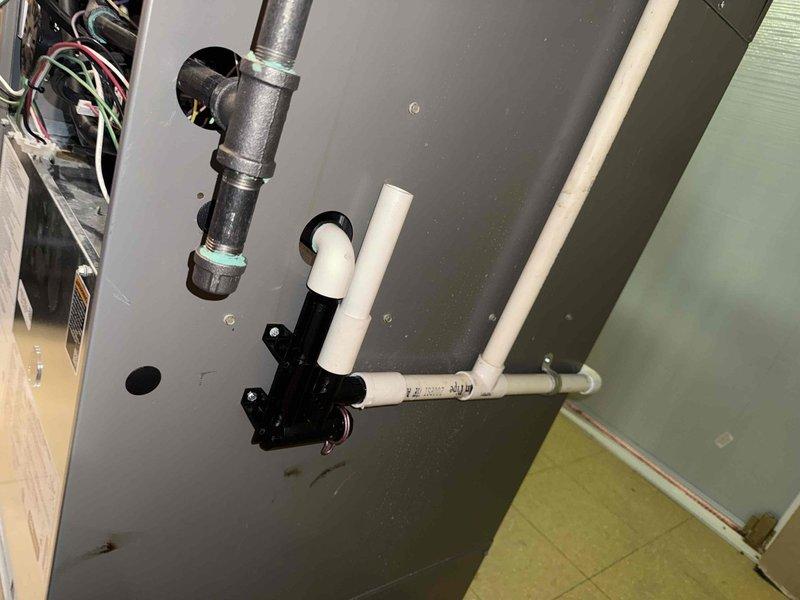 Diagnosed high pressure switch issue on thermostat of one-year-old HVAC system located in lower level. System remains operational for both heating and cooling functions despite the fault. Documented system condition with photos of plumbing components and interior furnace assembly including wiring connections. Parts ordered through Lennox under PO: 1287586-001.