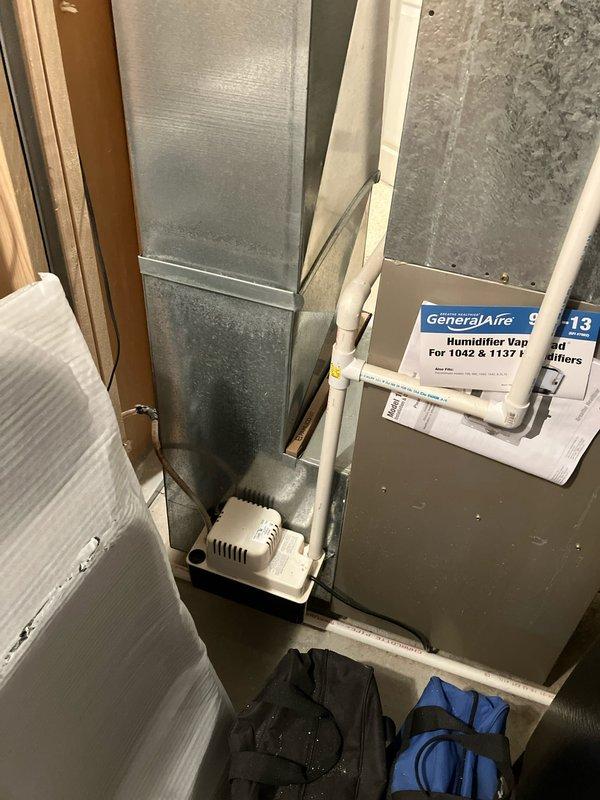 Completed assessment of 23-year-old Bryant furnace and AC system for potential replacement. Inspected existing installation in basement utility area, including connected ductwork, GeneralAire humidifier (model GF-13 for models 1042/1137), and PVC condensate drainage system. Documented current equipment condition and layout to prepare comprehensive replacement estimate for both heating and cooling components.