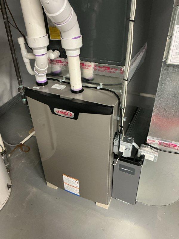 Performed annual Gold Furnace Inspection on 1-year-old Lennox furnace system located in basement. Inspected burner assembly with flame sensors and verified proper ignition sequence with blue flame indication. Checked all electrical connections, PVC ventilation components, and examined blower motor assembly for optimal performance, confirming system is operating within manufacturer specifications.