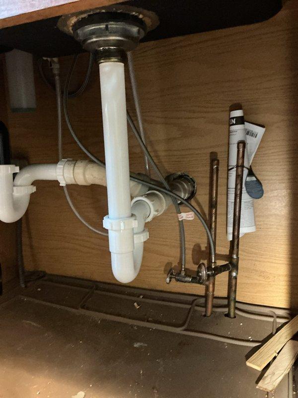 Responded to service call for kitchen sink clog causing backup issues. Inspected dual-basin stainless steel sink and PVC P-trap assembly. Successfully cleared blockage in drain line that was causing recurring backup problem previously reported by customer.