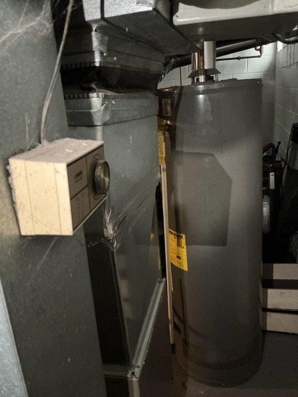 Completed full system estimate for existing HVAC installation, examining furnace with connected metallic ductwork, visible seams, and metal tape/sealant work. Inspection included evaluation of water heater with associated copper piping and control components, documenting current system condition through comprehensive photography for quote preparation.