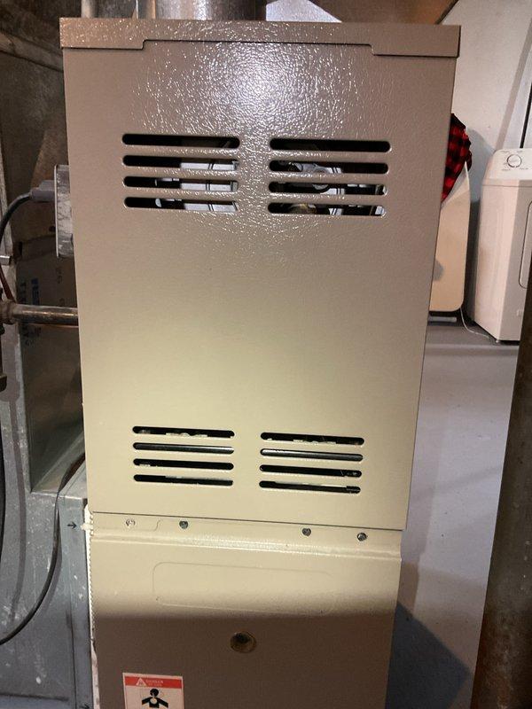 Performed city certification inspection on furnace over 10 years old located in basement. Conducted electrical testing with multimeter on control board, verifying proper voltage readings (0.642). Inspected and tested humidifier, thermostat, and hot water tank as part of comprehensive system evaluation. Unit appears to be in normal operating condition with no visible damage or deterioration.