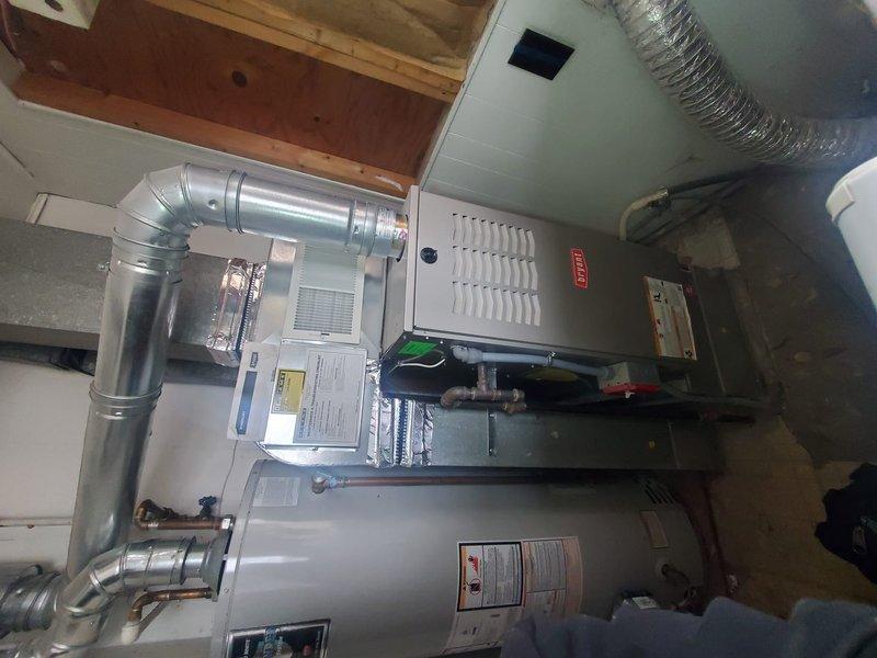 Diagnosed intermittent heating failure on Emerson thermostat-controlled system that was shutting down during windy conditions. Inspected furnace installation and ductwork in basement, finding proper component installation with no visible damage. Resolved issue by adjusting thermostat programming and verifying system operation through complete heating cycle.