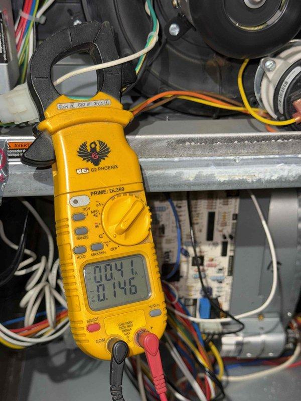 Performed diagnostic testing on furnace system that was failing to cycle off properly. Used UEi DL369 Phoenix clamp meter to measure electrical current values on blower motor and inducer motor components (readings of 004.1/0.146 and 0.000/15.49 observed). Identified and corrected control circuit issue causing continuous operation.