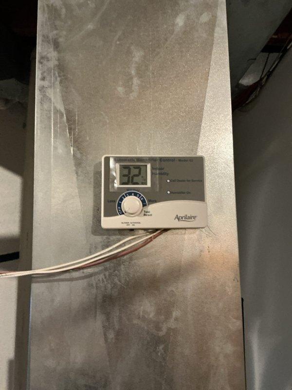 Responded to service call for Aprilaire humidifier showing red service light. Inspected system and replaced steam canister and electrodes to restore proper operation. Verified Atmor tankless water heater (installed 11-2019) was functioning correctly and confirmed humidity control panel now displays appropriate readings.