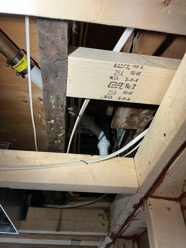 Responded to water leak complaint from previous service. Inspected area and found corroded metal surface where PVC drain pipe passes through, with visible moisture damage and rust. Resealed pipe penetration and verified proper drainage to resolve persistent leak affecting lower level.