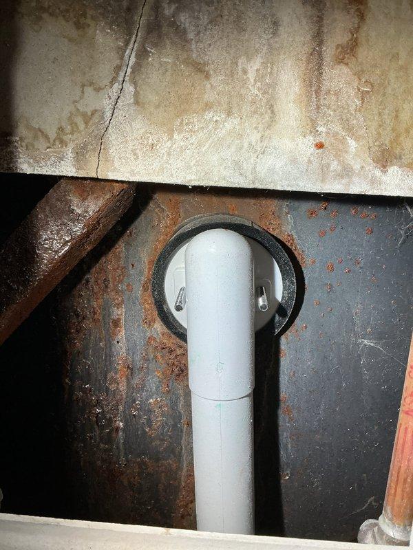 Responded to water leak complaint from previous service. Inspected area and found corroded metal surface where PVC drain pipe passes through, with visible moisture damage and rust. Resealed pipe penetration and verified proper drainage to resolve persistent leak affecting lower level.