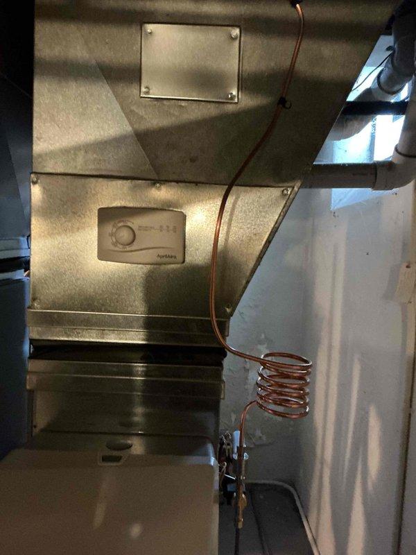 Completed installation of an Aprilaire humidifier with required connections, including 6" supply ductwork (3' total) and 10' of PVC drain line. System was properly mounted, with copper feed line installed and controller set up on the furnace housing for optimal humidity regulation.