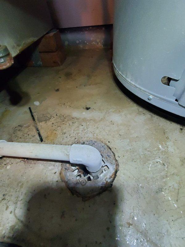 Responded to service call for furnace not holding temperature despite recent thermostat battery replacement. Inspected Bryant thermostat and verified proper operation with display showing correct temperature (72°F). Examined basement utility area including drainage system and associated mechanical components; found system functioning normally with no issues requiring repair.