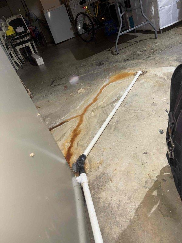 Responded to no cooling complaint on 10-year-old furnace system. Diagnosed significant corrosion on evaporator coil and discovered condensate drain leak causing rust staining on basement floor. Cleaned accessible components but recommended system replacement due to age and extent of deterioration.