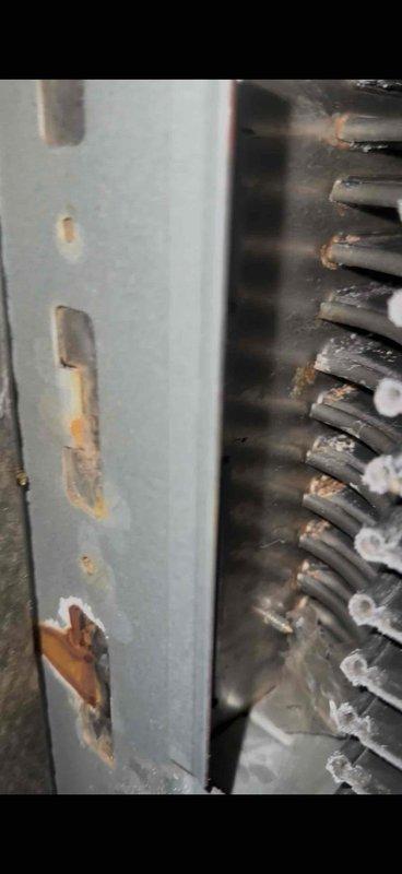 Responded to no cooling complaint on 10-year-old furnace system. Diagnosed significant corrosion on evaporator coil and discovered condensate drain leak causing rust staining on basement floor. Cleaned accessible components but recommended system replacement due to age and extent of deterioration.