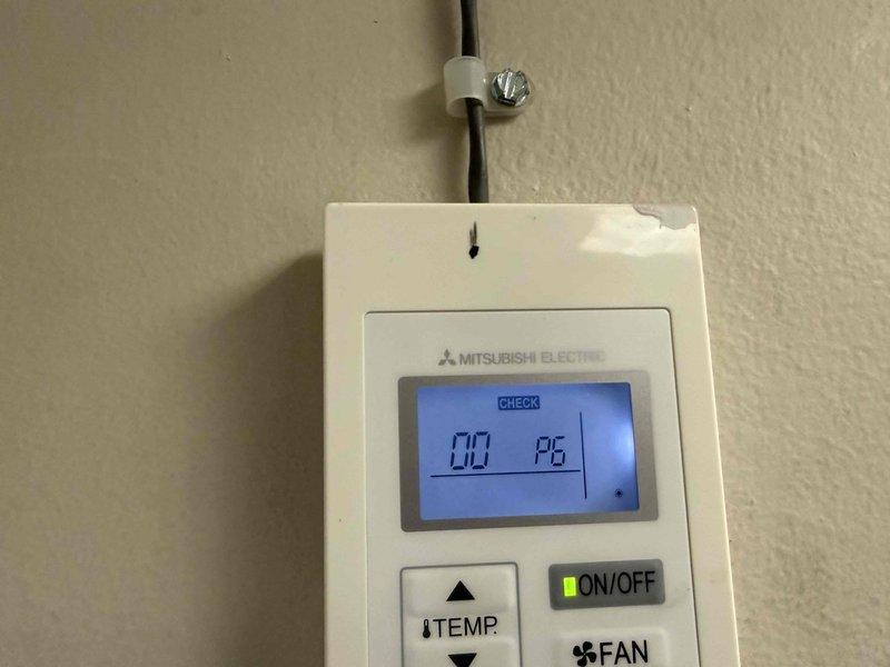 Responded to service call for Mitsubishi PKA-A36KA74y split system heat pump not producing cold air. Diagnostic check revealed error code displayed on the wall controller and significant debris buildup in the ventilation system. Cleaned accumulated dirt from air return grid to restore proper airflow and reset system, resolving the cooling issue.