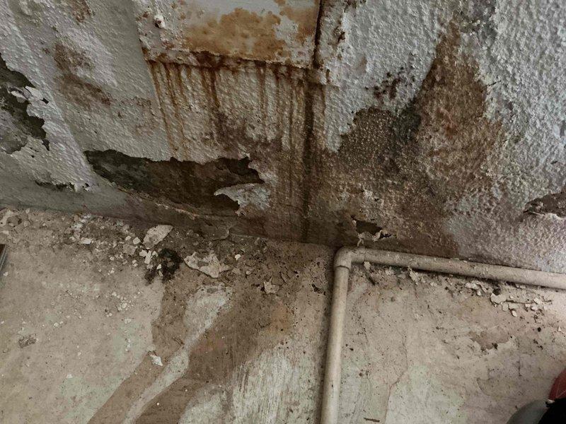 Responded to no-heat call for 10+ year old furnace with operational blower but non-functioning burner. Inspection revealed severe water damage and mold growth on nearby wall, along with condensation at the duct connection point. Determined moisture intrusion was causing system failure and recommended immediate remediation of water damage and evaluation of potential furnace replacement due to age and condition.