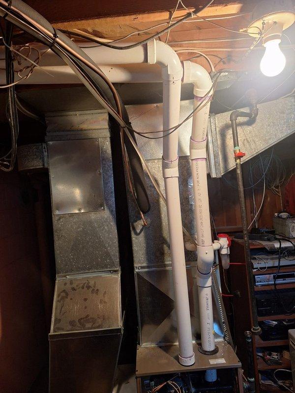 Successfully completed furnace installation (70,000 BTU) with all required mechanical and electrical connections. Installed new PVC venting system with proper joints and connections, visible in the utility area with appropriate clearances. All components were properly secured and connected to existing ductwork with permits obtained for mechanical, electrical, and reconnection work.
