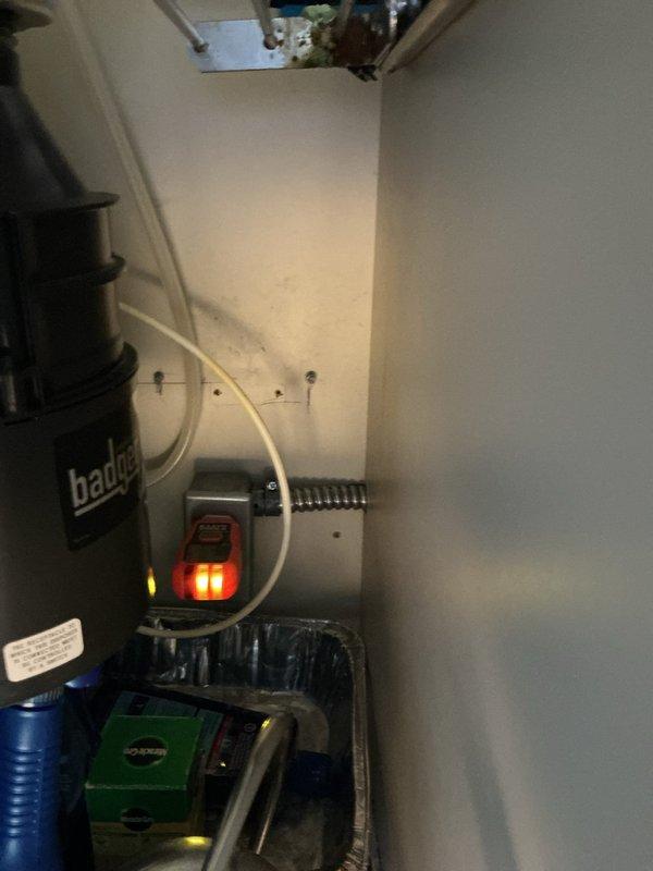 Responded to service call for non-functioning dishwasher outlet. Discovered electrical connection issue in the area under sink where disposal unit is installed. Repaired wiring connection and verified outlet functionality with voltage tester, ensuring proper power supply for upcoming dishwasher installation. Documented repair with photos for verification purposes and communicated successful resolution to client.