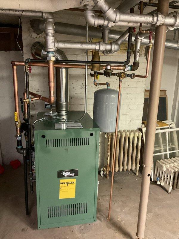 Successfully installed new green boiler system in customer's basement with complete copper pipe network integration. System includes expansion tank, appropriate valves, and connections to existing radiators, with all mechanical and reconnection work completed per permit requirements.