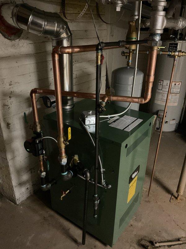 Successfully installed new green boiler system in customer's basement with complete copper pipe network integration. System includes expansion tank, appropriate valves, and connections to existing radiators, with all mechanical and reconnection work completed per permit requirements.
