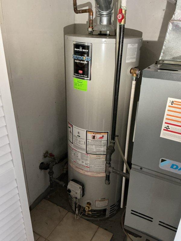 Diagnosed and serviced Bradford White water heater (installed 9/2020) experiencing intermittent pilot light failure. Inspected gas supply, thermocouple, and pilot assembly, finding carbon buildup affecting proper ignition. Cleaned components, adjusted pilot flame, and verified stable operation after repair. Unit is now functioning properly under existing warranty.